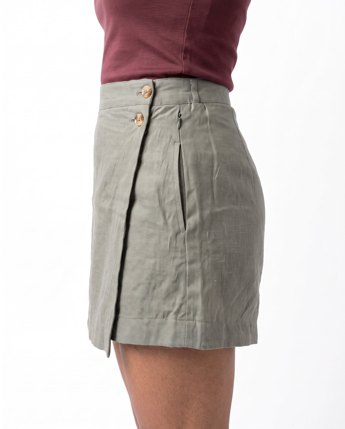 Grey linen skort with pockets, right side view showing buttons and wrap flap