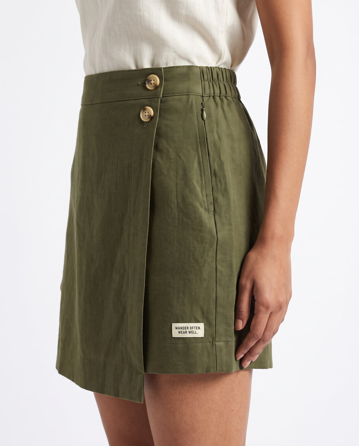 Olive linen skort with pockets, right side showing the two buttons and wrap flap