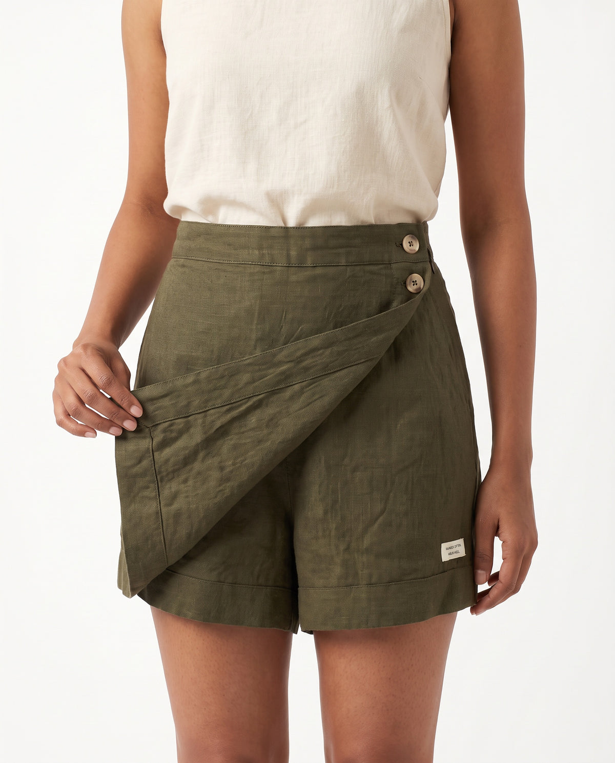 Olive linen skort with pockets, wrap flap lifted to show the shorts underneath