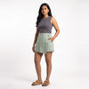 Sage linen skort with pockets, front view on model