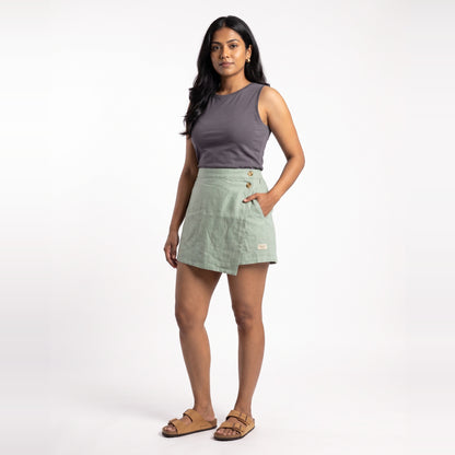 Sage linen skort with pockets, front view on model