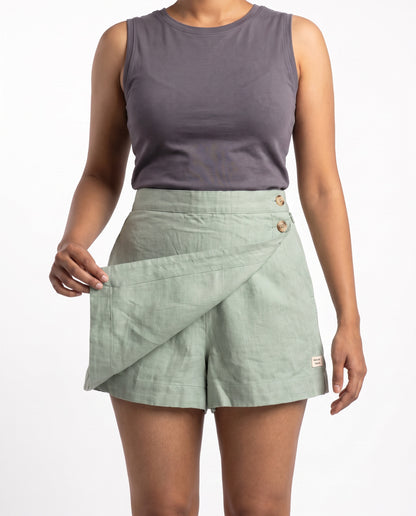 Sage linen skort with pockets, wrap flap lifted to show the shorts underneath