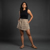 Taupe linen skort with pockets, front view on model