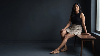 Taupe linen skort with pockets, seated, showing ease of movement